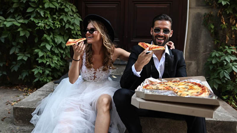 Wedding guests order pizza and wings